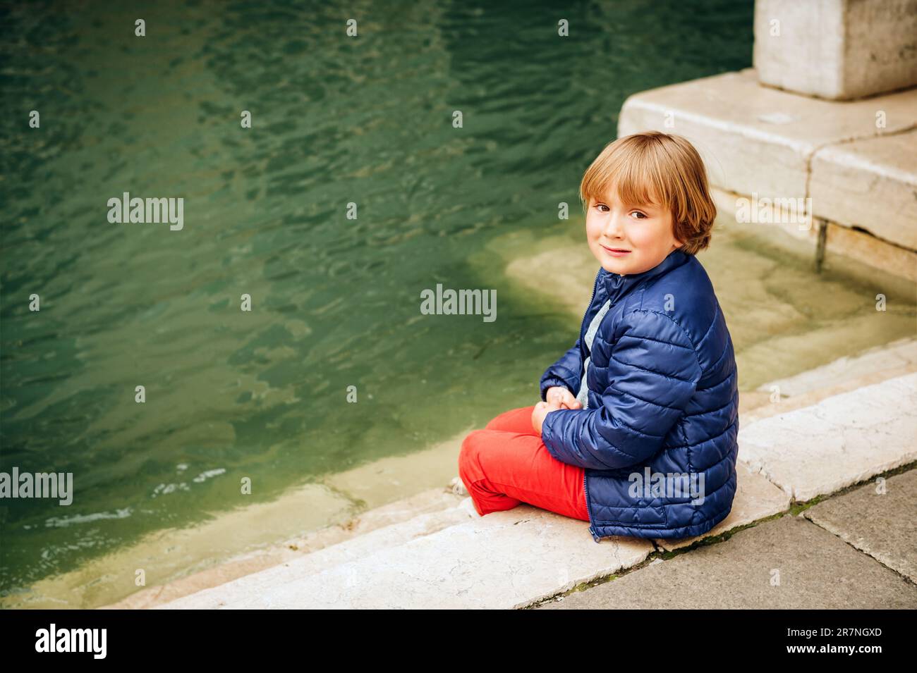 Ein kleiner Junge, der auf den Straßen von Venedig spielt. Familienreisen mit Kindern Stockfoto
