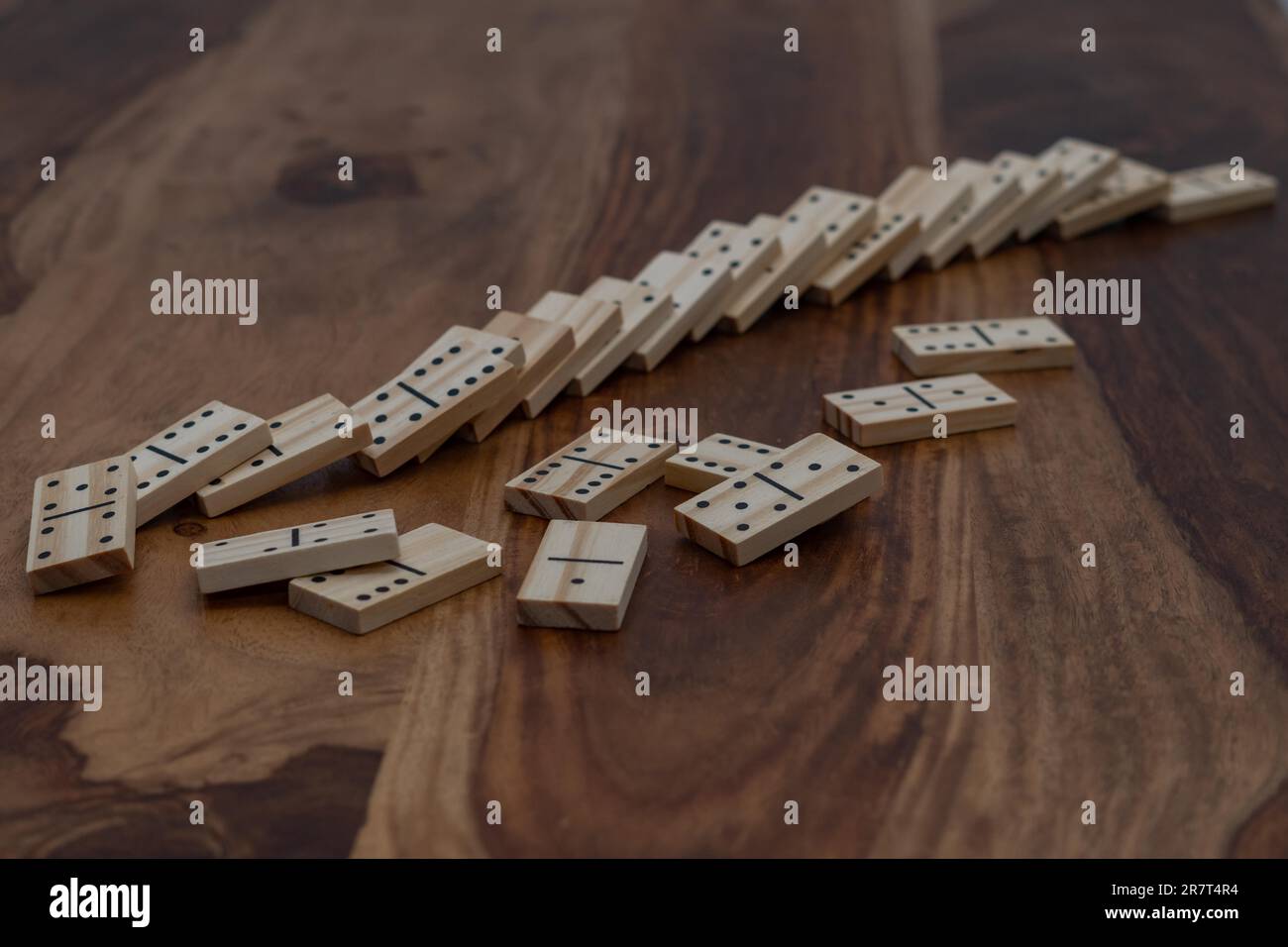 Hölzerne Dominosteine in einer Reihe auf einem Holztisch Stockfoto