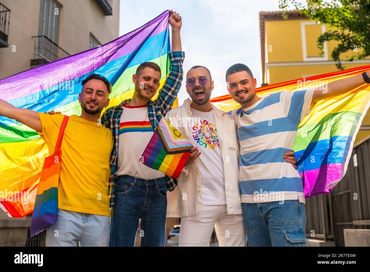 Lebensstil homosexueller Freunde, die sich auf einer Schwulenparty in der Stadt umarmen, Vielfalt junger Menschen, Demonstration mit Regenbogenflaggen, lgbt-Konzept Stockfoto