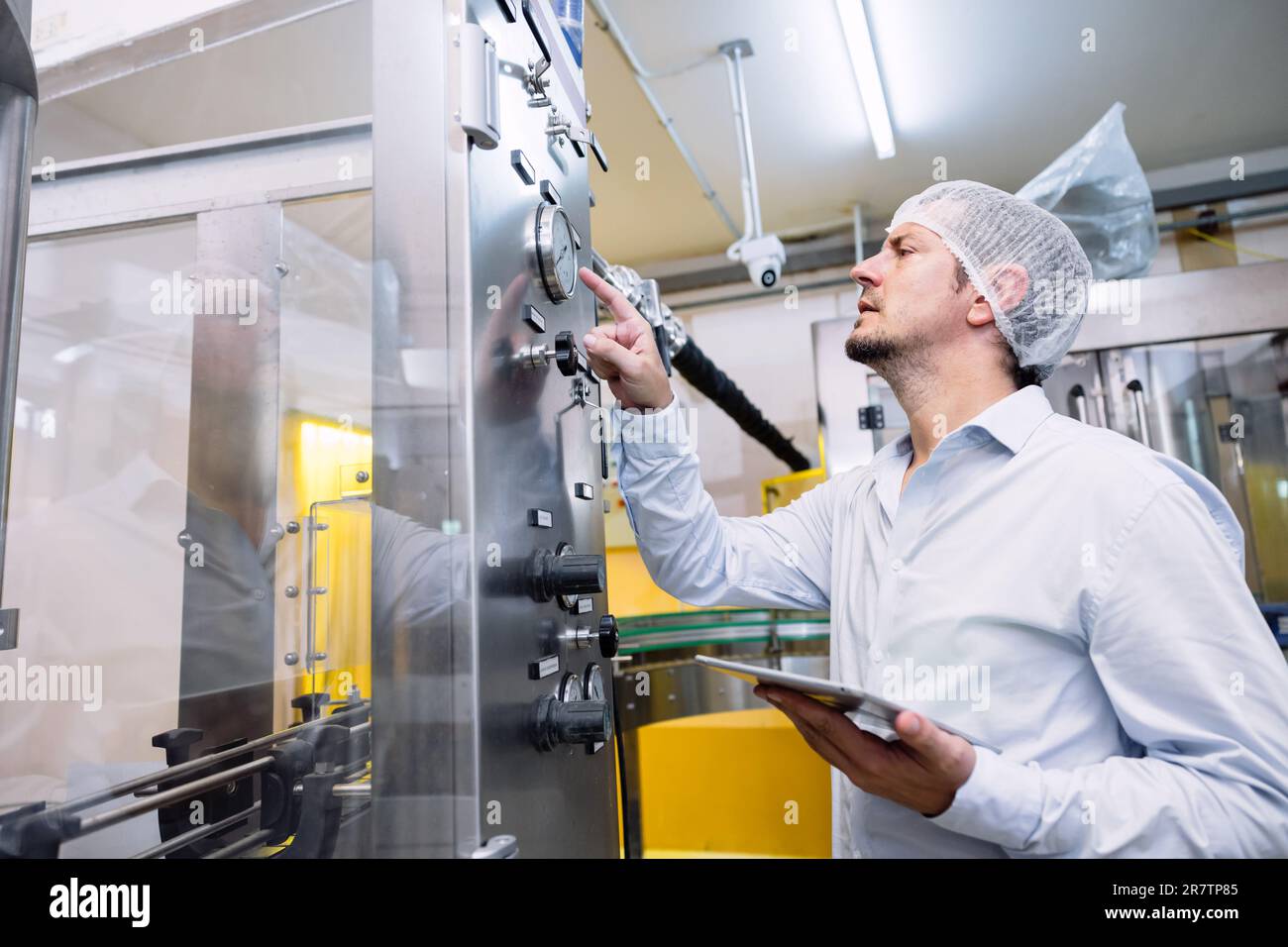 Ingenieur der automatischen Arbeitseinrichtung für Männer in der Lebensmittelindustrie. Stockfoto