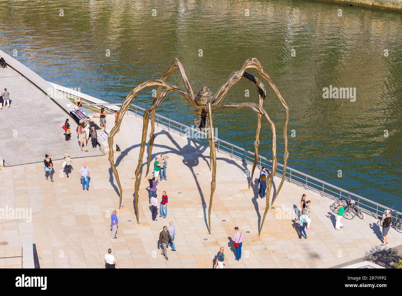 Die Maman Bronze, Edelstahlskulptur des Künstlers Louise Bourgeois in der Stadt Bilbao. Stadtmenschen, Touristen, Menschen genießen den sonnigen Tag in Stockfoto