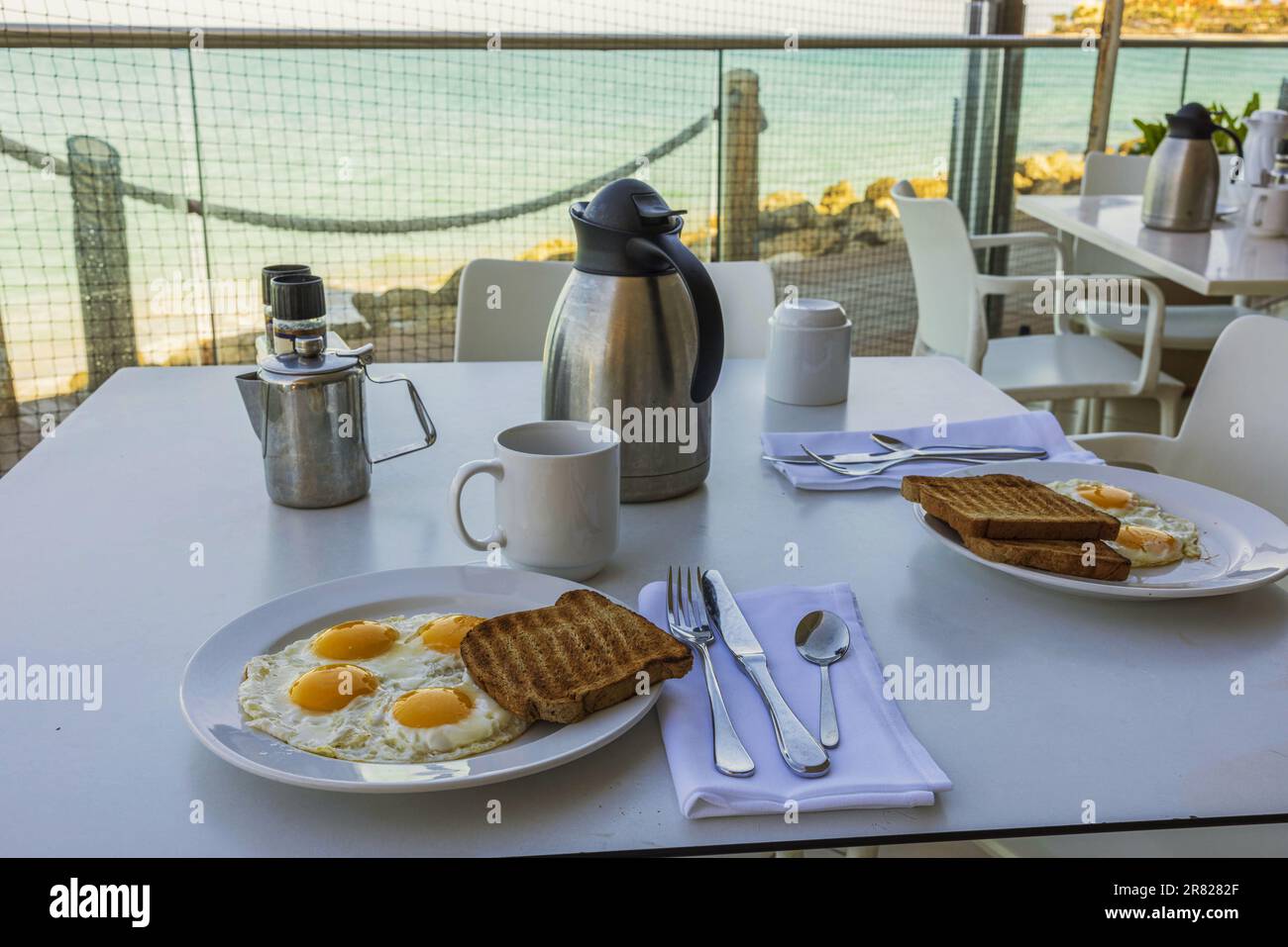 Blick auf den Frühstückstisch im Open-Air-Hotelrestaurant an der Atlantikküste aus nächster Nähe. Aruba. Stockfoto