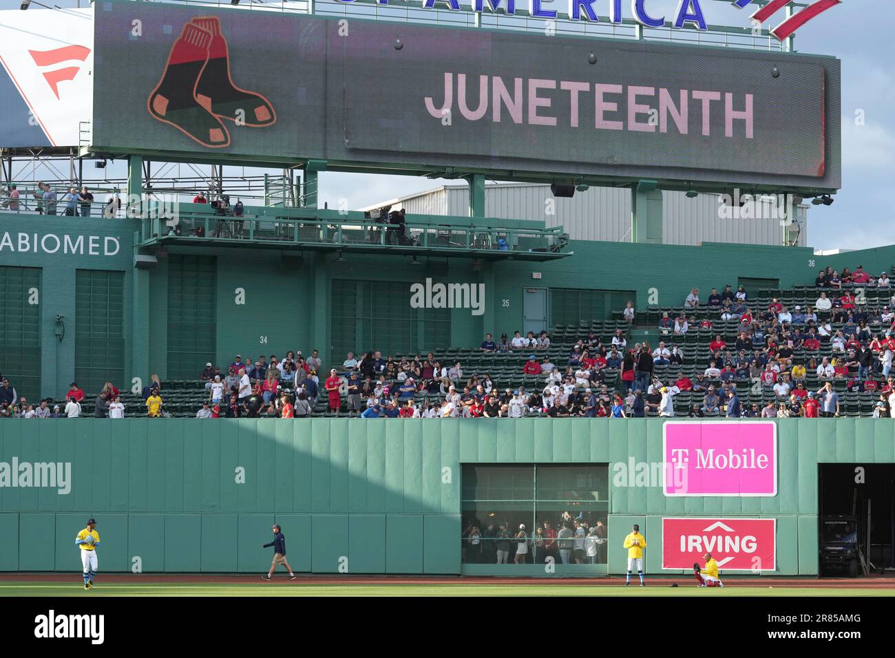 A display on a scoreboard shows a boston red sox emblem featuring