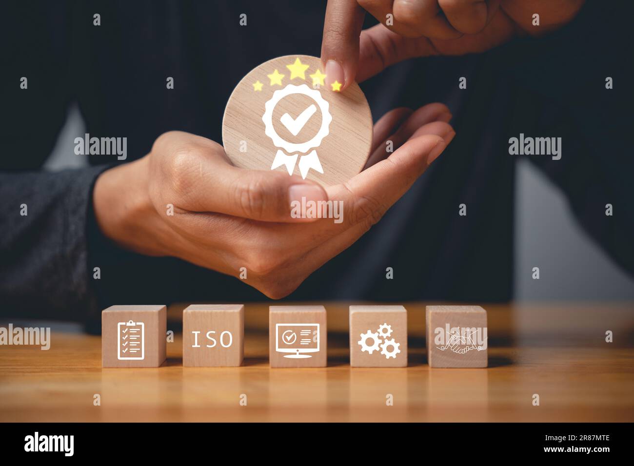 Der Finger eines Geschäftsmannes, der ISO-Holzwürfel drückt Stockfoto