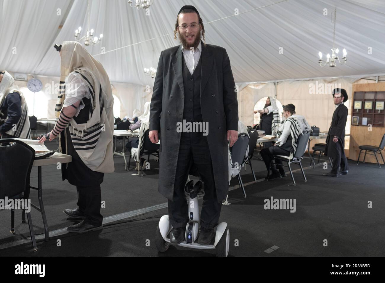 Ein orthodoxer Jude auf einem Hoverboard in einer Synagoge in Monsey, New York. Stockfoto