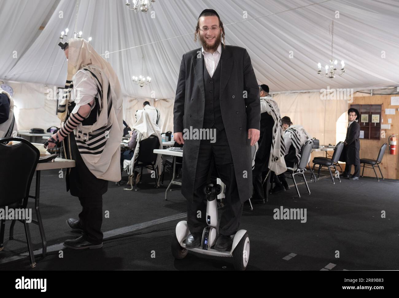 Ein orthodoxer Jude auf einem Hoverboard in einer Synagoge in Monsey, New York. Stockfoto