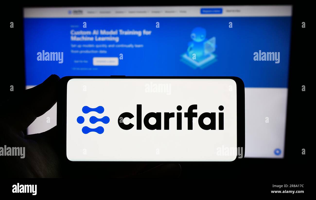 Person, die ein Smartphone mit dem Logo des US-amerikanischen Unternehmens Clarifai Inc. Auf dem Bildschirm vor der Website hält. Konzentrieren Sie sich auf das Display des Telefons. Stockfoto