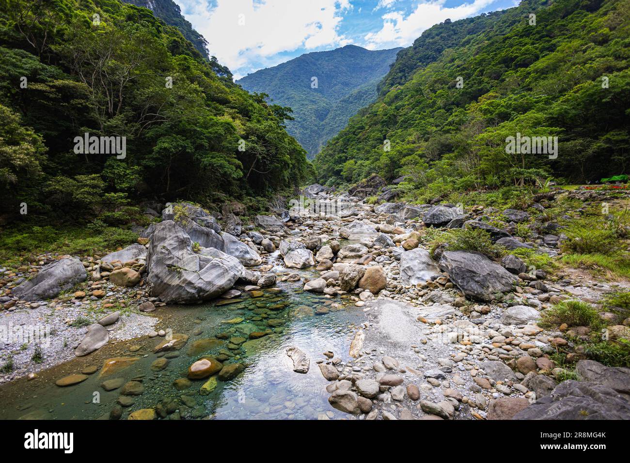 Idyllisches Foto eines Flusses, der sich durch das Tal des Taroko-Nationalparks schlängelt. Seidiges Wasser fließt über große Steine und schafft eine ruhige Atmosphäre. Im Shak Stockfoto