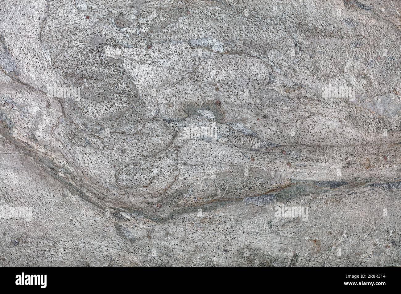 Die Oberfläche der vulkanischen Lava mit Flecken und Streifen nach dem Abkühlen und der Umwandlung in Stein. Natürliche graue Textur und Hintergrund. Stockfoto