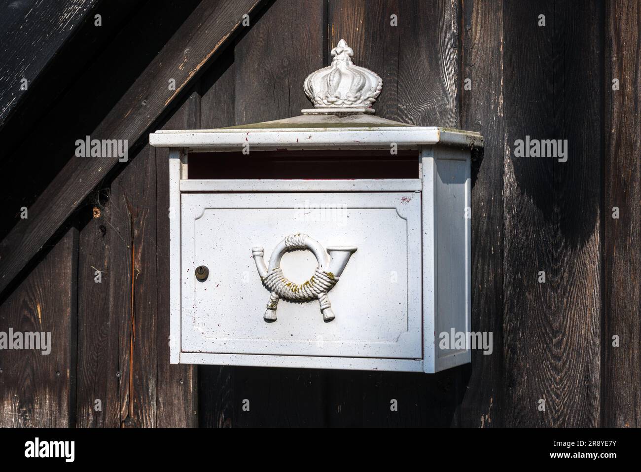 Briefkastenpostfach Metall Horn in Deutschland. Ländlicher Holzzaun - sonniger Tag. Stockfoto