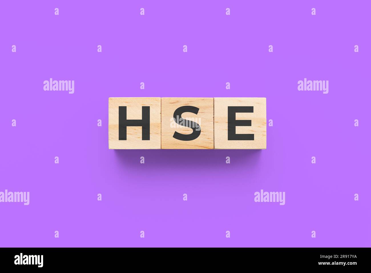 HSE (Health Society and Environment) Holzwürfel auf violettem Hintergrund Stockfoto