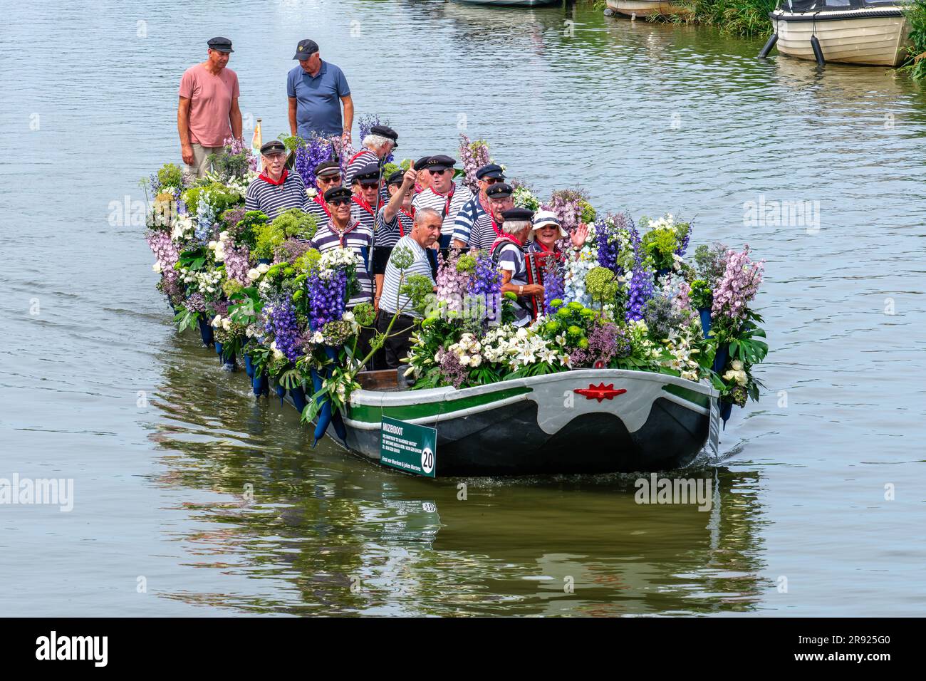 SCHIPLUIDEN, NIEDERLANDE - 23. JUNI 2023 : jährliche farbenfrohe Kanalparade mit Blumen und Gemüse dekorierte Boote mit fröhlichem Gesang Stockfoto