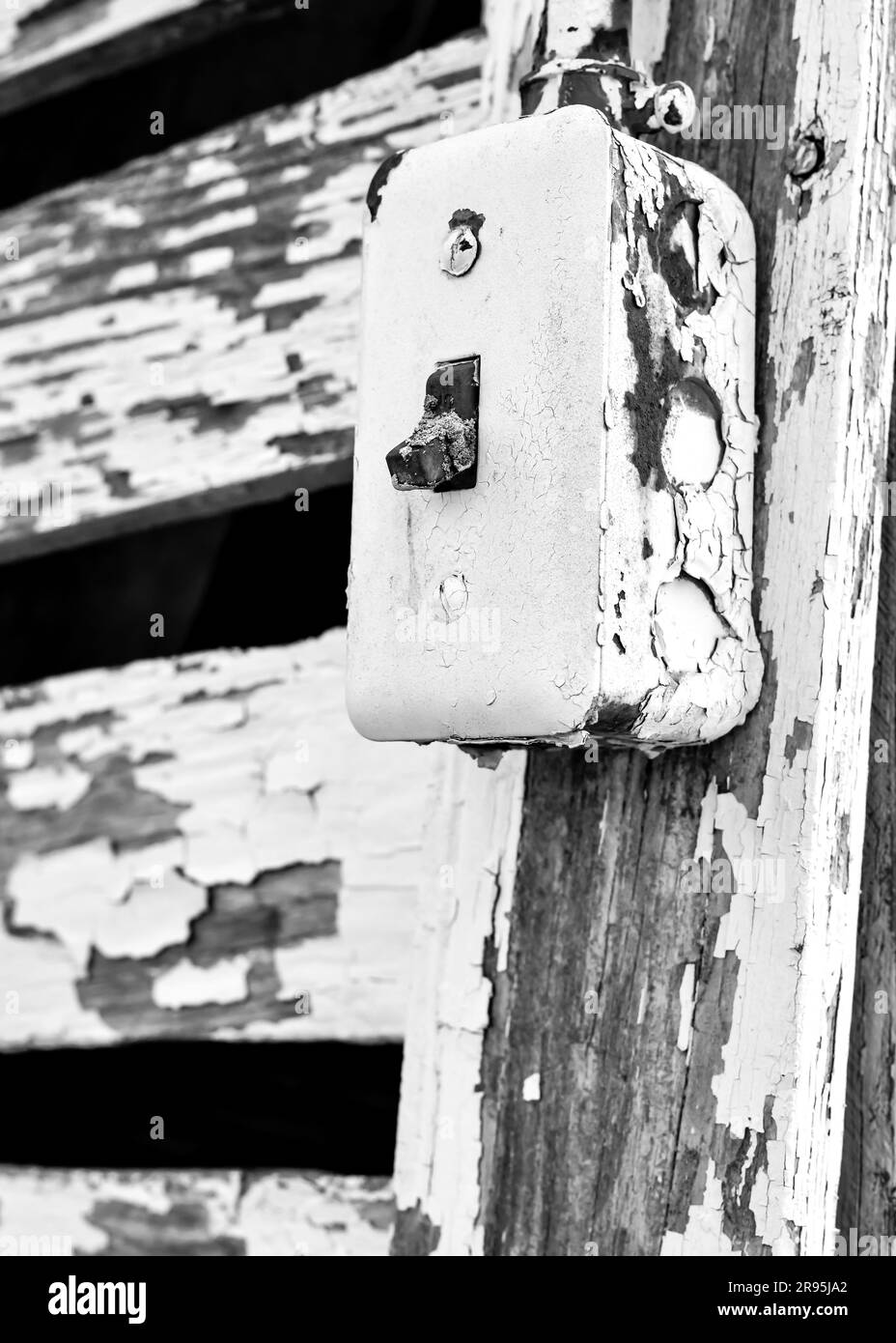 Ein alter alter elektrischer Schalter an der Scheunentür Stockfoto