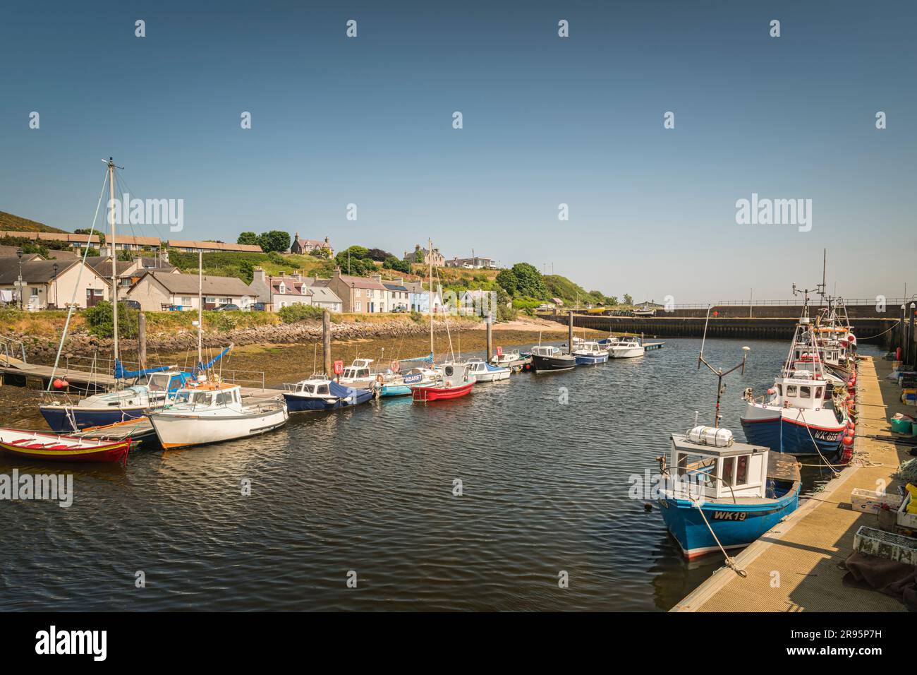 Ein warmes, sommerliches HDR-Bild von Booten im Hafen und Yachthafen von Helmsdale, Sutherland, Schottland. 14. Juni 2023 Stockfoto