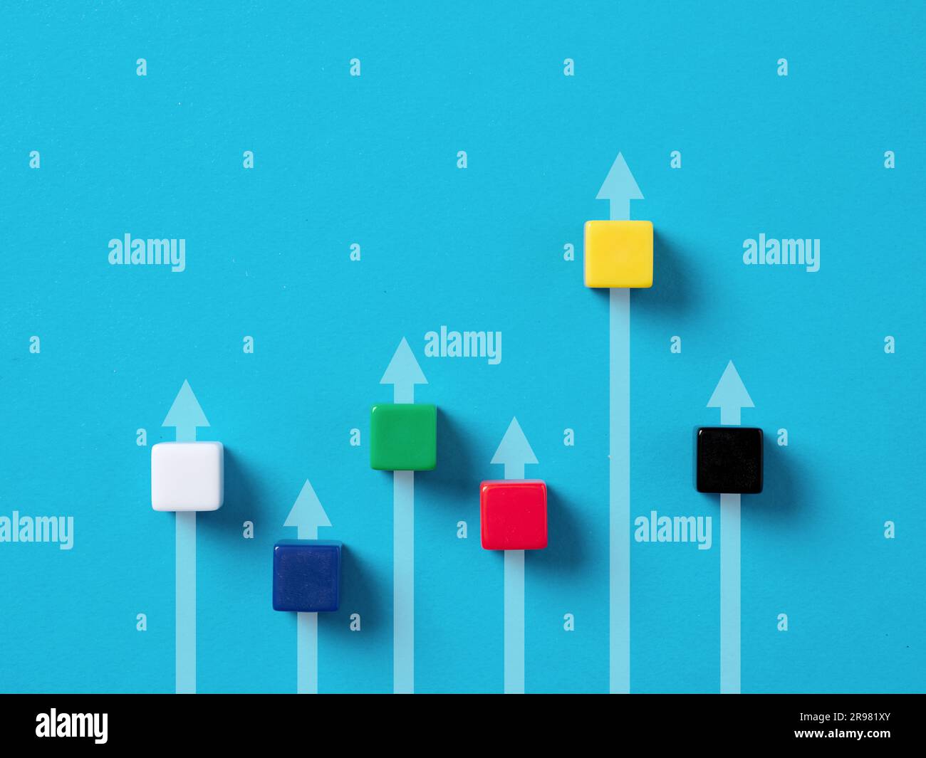 Wettbewerb und Führungsherausforderung. Erfolgreichstes Start-up-Unternehmen. Bunte Würfel mit Pfeilen auf blauem Hintergrund. Stockfoto