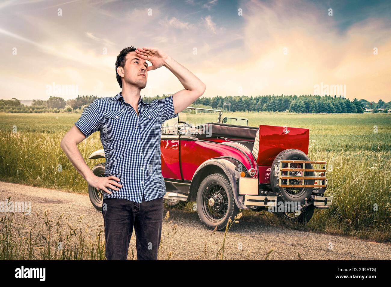Auto der Kraftstoff in einer ländlichen Gegend mit einem Mann in einer blauen Hemd Scouting für Hilfe Stockfoto