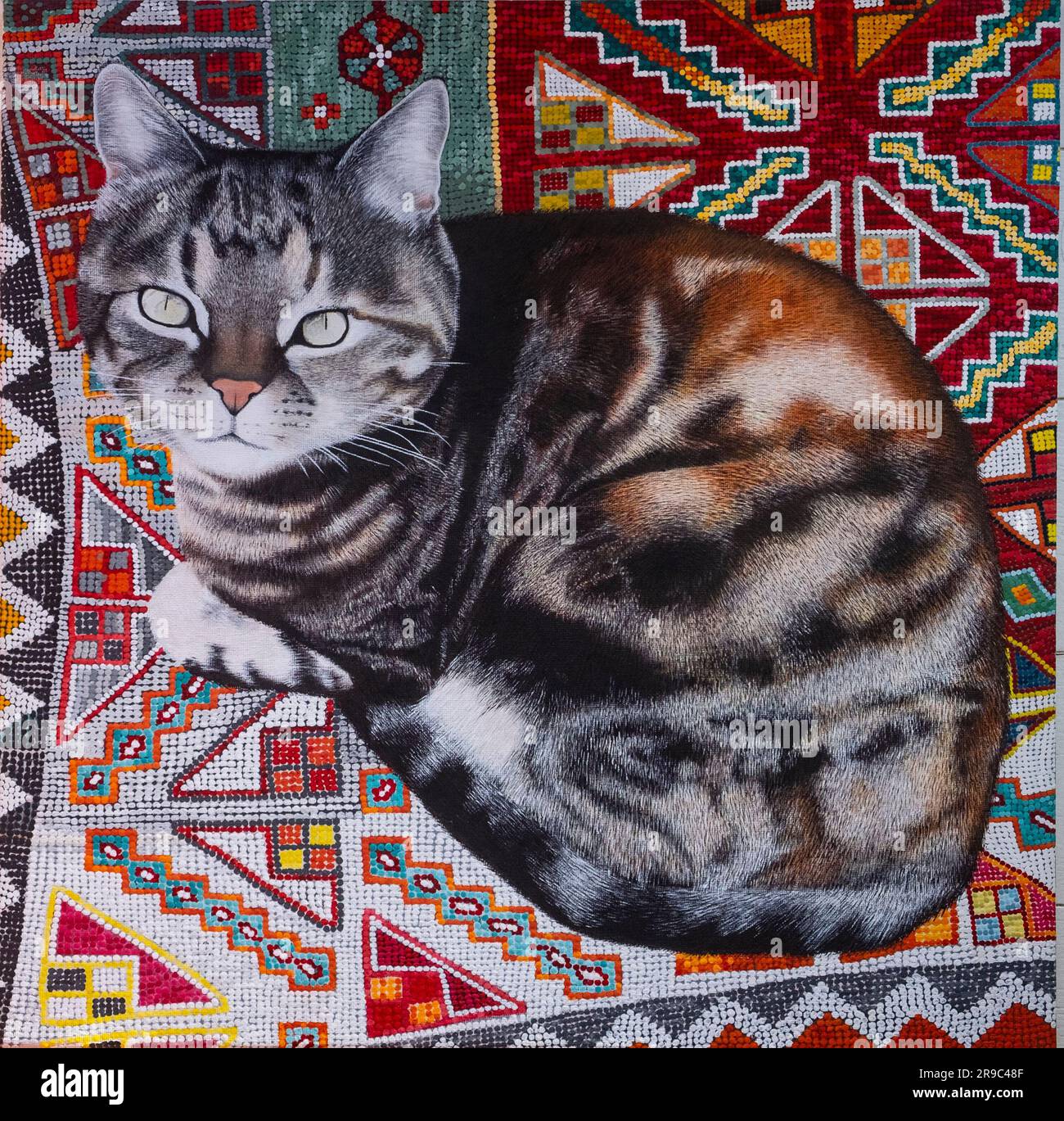 Malerei auf Leinwand in Acryl einer Tabby-Katze auf einem persischen Teppich durch die Künstlerwand Cassandra Stockfoto
