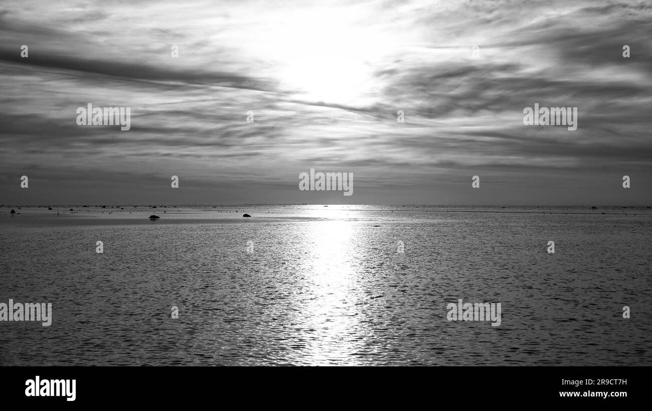 Sonnenuntergang, Möwen am Himmel. Lichtwellen. Schwarzweiß-Aufnahme. Poelinsel an der Ostsee. Naturfoto von der Küste Stockfoto