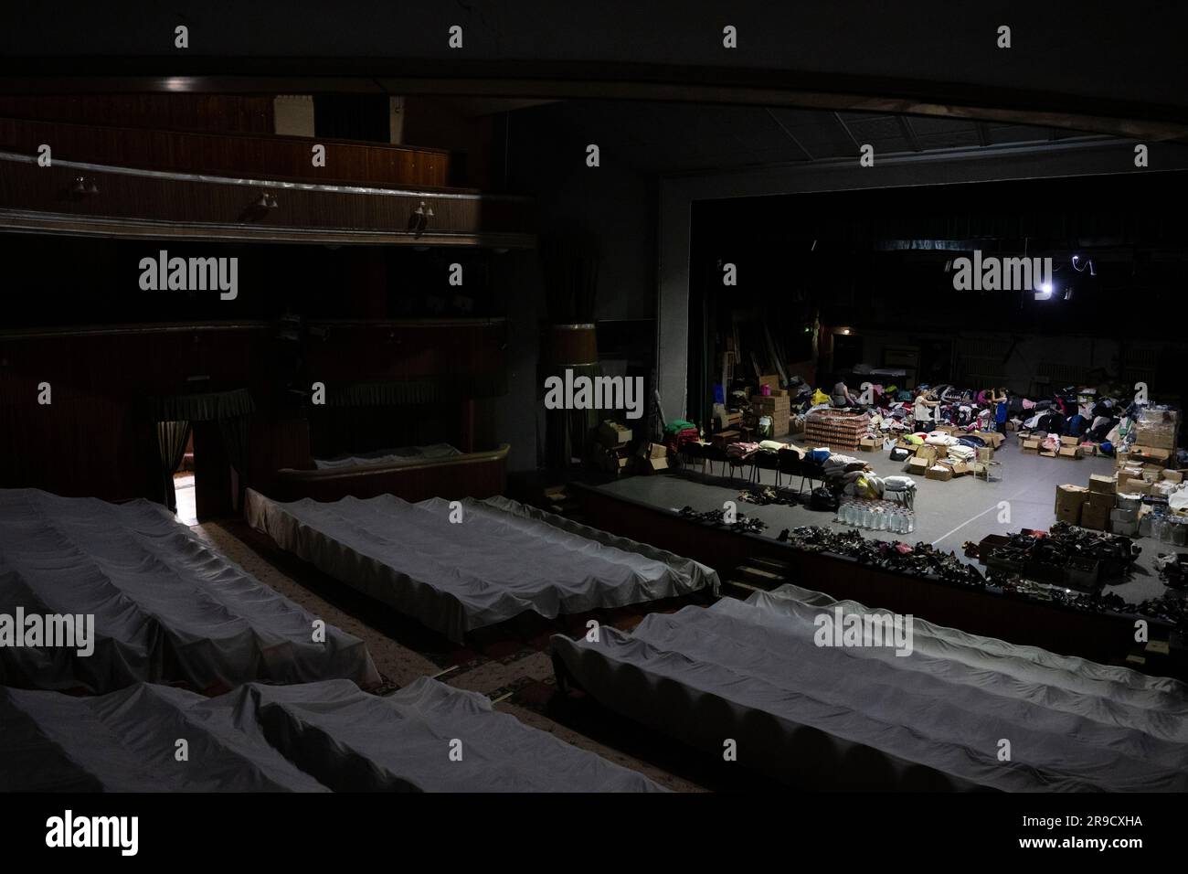 Cherson, Ukraine. 24. Juni 2023. Eine Frau sortierte humanitäre Hilfe für die von der Flut betroffenen Menschen im Kherson Music and Drama Theater von Mykola Kulish in einem Luftschutzbunker in Kherson, Ukraine, am 24. Juni 2023. Der Kakhovka-Staudamm in der Ukraine wurde in den frühen Morgenstunden des 6. Juni 2023 zerstört und verursachte umfangreiche Überschwemmungen entlang des unteren Dnieper-Flusses in der Oblast Kherson. Kredit: Ondrej Deml/CTK Photo/Alamy Live News Stockfoto