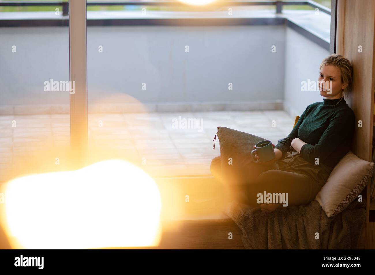 Schönes Mädchen trinkt Kaffee in einer gemütlichen Umgebung. Stockfoto