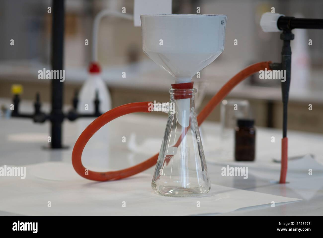 buchner-Trichter aus Porzellan, der unter Vakuum filtert. Stockfoto