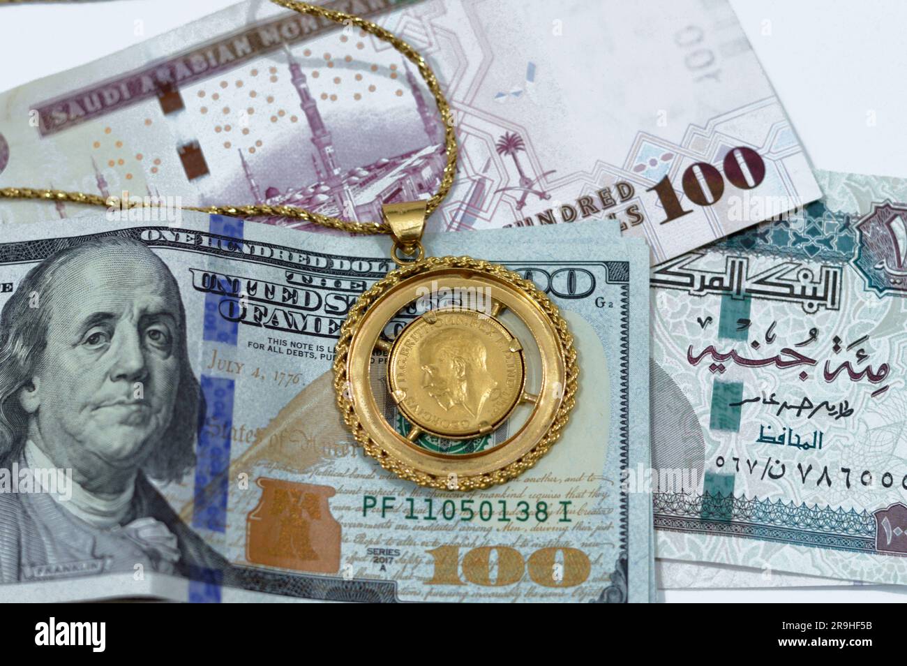Amerikanische Dollar, ägyptische Pfund und Saudi-Arabische Riesen-Banknoten Geldwechsel Geld mit britischen Goldmünzen Formen Goldmünzen Stockfoto