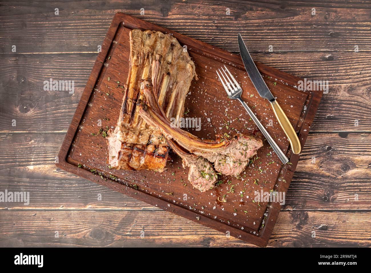 Gegrillte Lammkoteletts auf einem hölzernen Servierteller Stockfoto