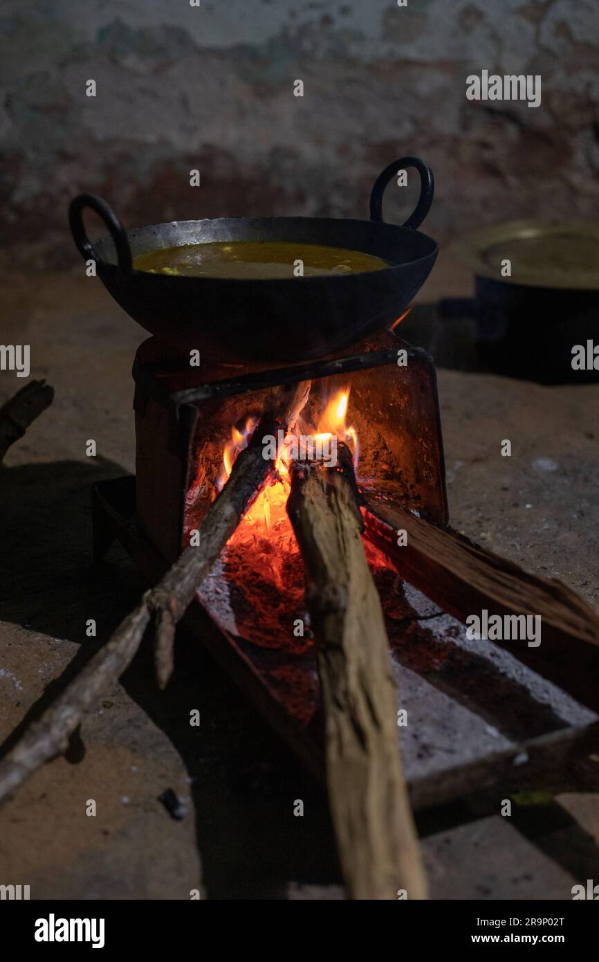 Ländliche Küche. Traditionelle Herde, die von Bewohnern des ländlichen Indiens verwendet werden, mit Holz betrieben, Kochen von Speisen auf dem Herd mit trockenen Blättern und Holz im Dorf Stockfoto