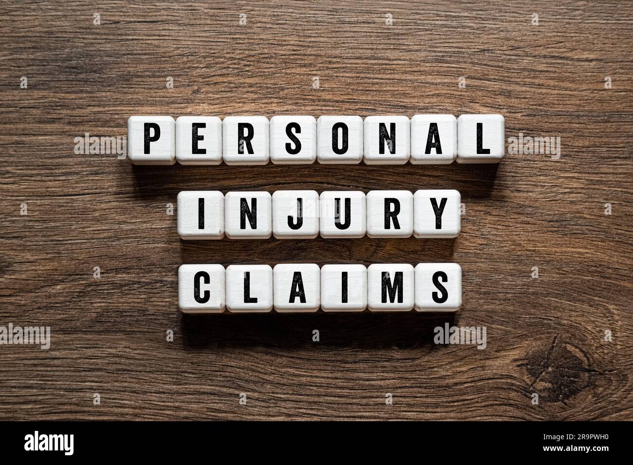 Verletzungsansprüche - Wortbegriff auf Bausteinen, Text, Buchstaben Stockfoto