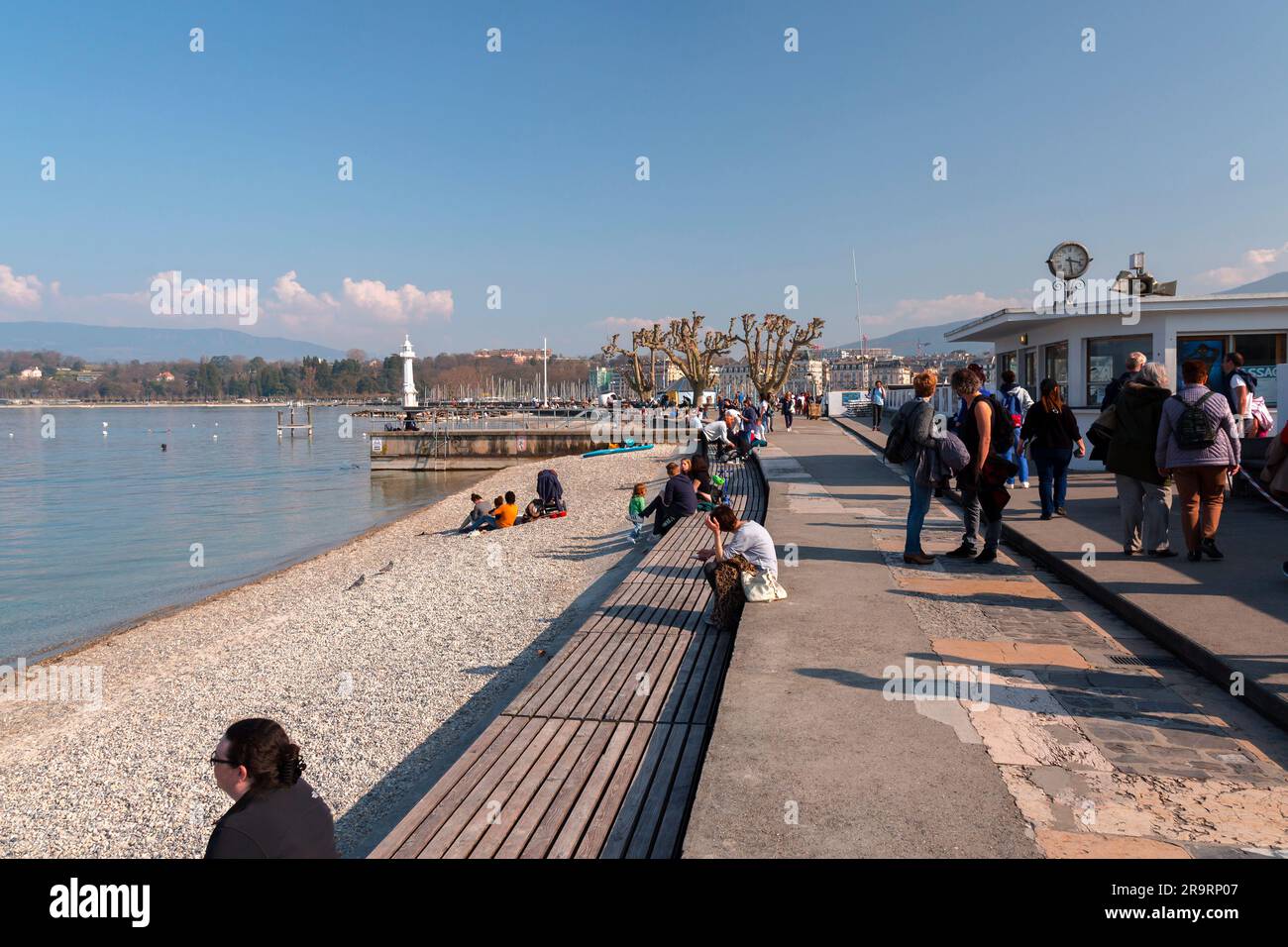Genf, Schweiz - 25. März 2022: Menschen genießen den malerischen Blick auf den Genfer See an der Bucht von Genf, dem französischen Teil der Schweiz. Stockfoto