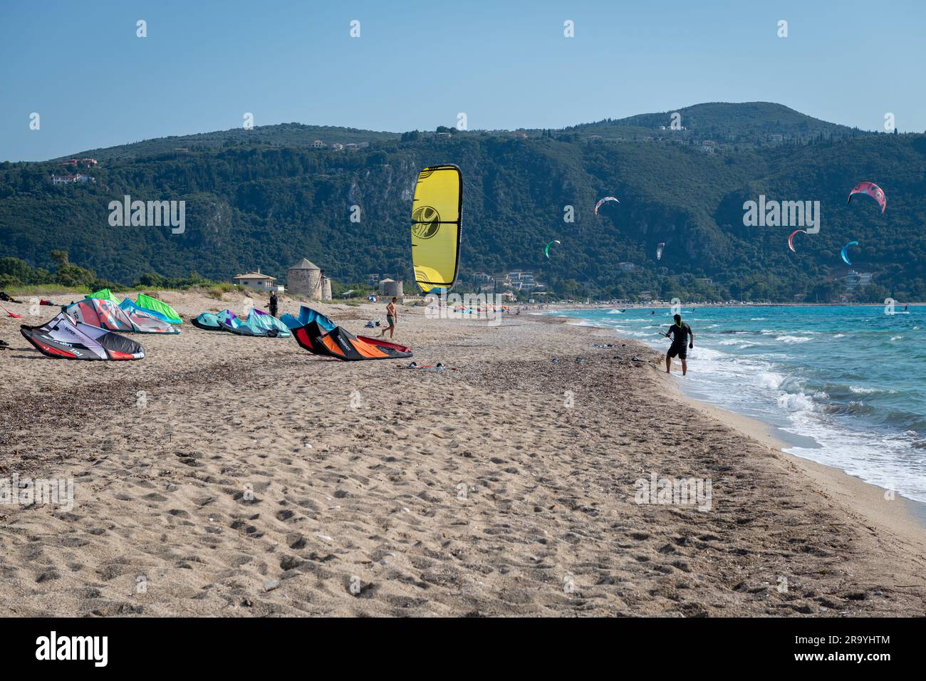 Die Insel Lefkada. Griechenland - 06.21.2023. Ein Zusammentreffen von Kitesurfleuten mit etwas Entspannung am langen Sandstrand und ein paar Surfern im Meer. Stockfoto