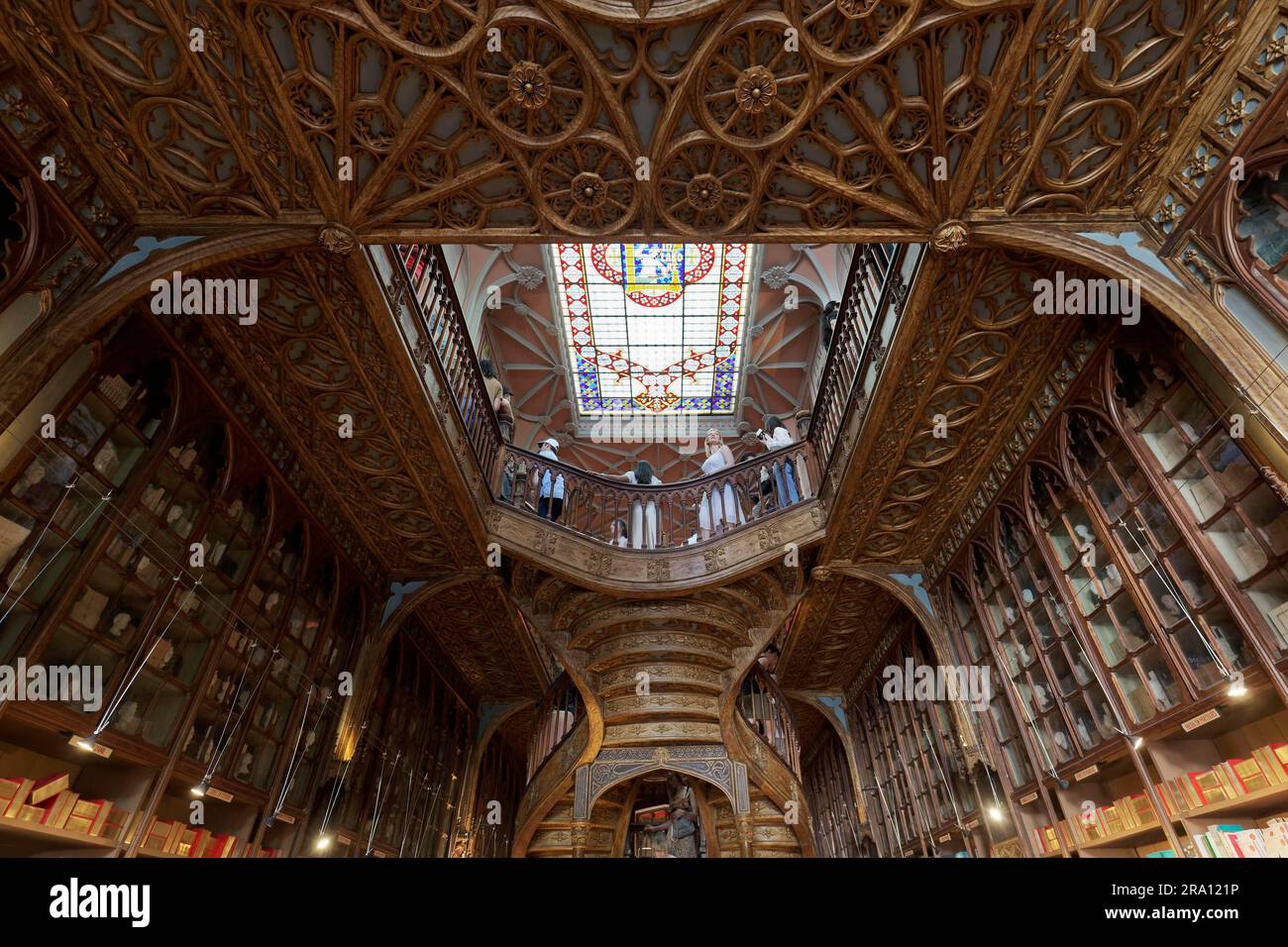 Buchhandlung Livraria Lello, Inneneinrichtung mit Jugendstilholztäfelung, kunstvoll verzierte Holztreppe, Porto, Portugal Stockfoto
