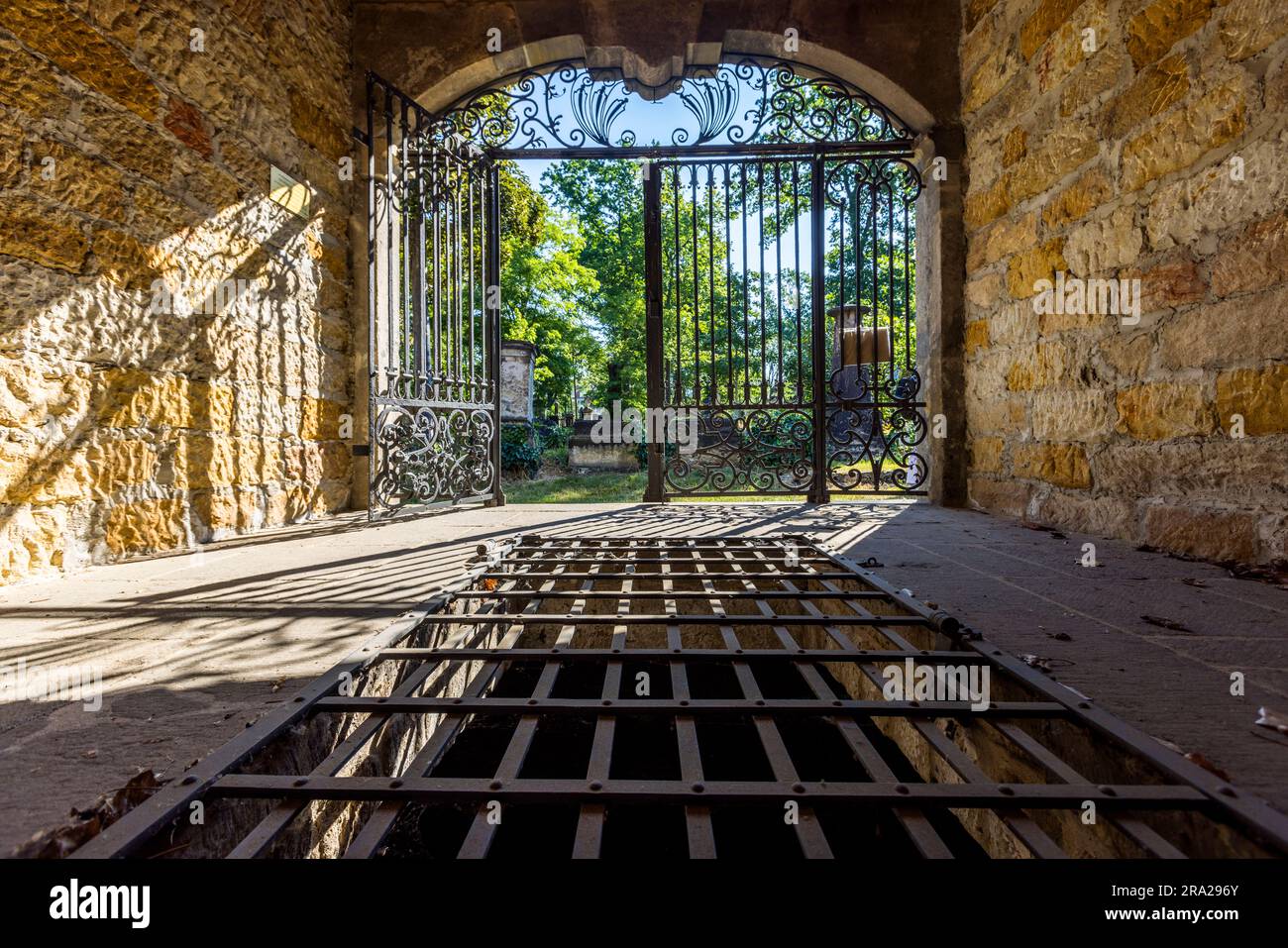 Blick aus einem Gruft-Haus auf dem Elias-Friedhof in Dresden. Unter dem Gitter befindet sich ein ummauerter Grabraum. Die Särge einer Familie wurden hier gestapelt. Diese Form der Bestattung verursachte jedoch, im Gegensatz zu irdenen Gräbern, eine große Geruchsbelästigung. Kryptengebäude mit bogenförmiger Front an der Friedhofswand sind eine Besonderheit des Elias-Friedhofs. Der Elias-Friedhof in Dresden ist seit 1876 stillgelegt und seit 1924 geschlossen Stockfoto