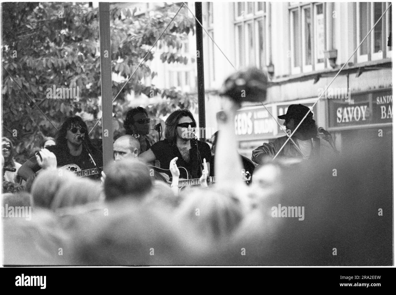 BON JOVI, FREIER AUFTRITT, CARDIFF BANDSTAND, 1995: Jon Bon Jovi von Bon Jovi spielte am 21. Juni 1995 einen kostenlosen Busking-Auftritt auf der Queen Street in Cardiff, Wales, Großbritannien. Der Auftritt war, um den schlecht verkauften Auftritt am nächsten Tag im Arms Park Stadium bekannt zu machen, und eine riesige Menschenmenge versammelte sich in Cardiff's Haupteinkaufsstraße. Foto: Rob Watkins Stockfoto