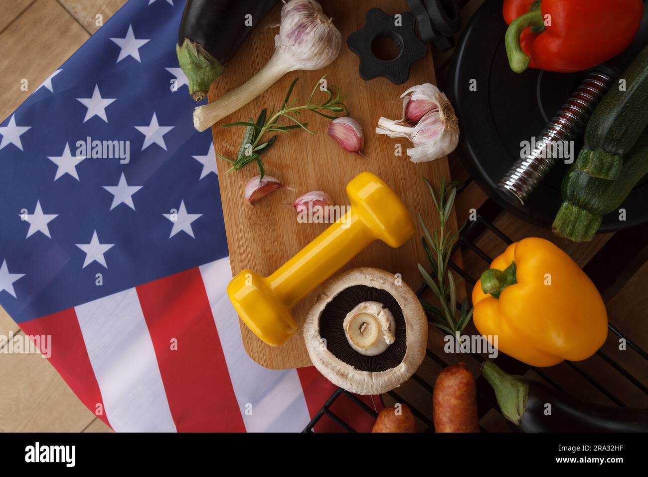 Gym Kurzhanteln, Essen und Flagge der Vereinigten Staaten von Amerika. Fit Barbecue-Party-Konzept für die Feiertagsfeier am 4. Juli in den USA. Stockfoto