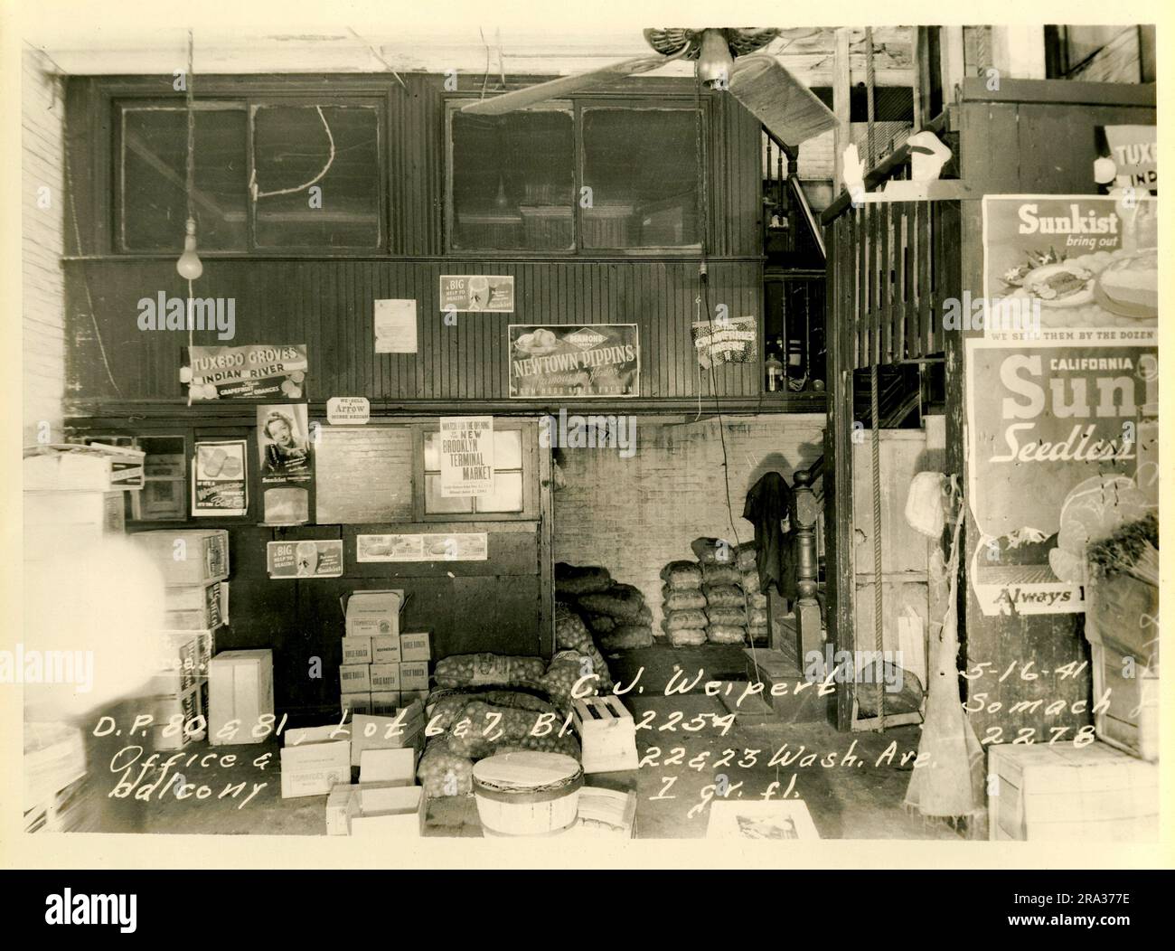 Foto von Interior Wallabout Market, D.P. 80 und 81, Los 6 und 7, Bl. 2254, 22-23 Wash. Ave. C.J. Wiepert, Büro Und Balkon. 1 g fl... Zimmer mit Blick auf das Büro auf Balkonebene und Ladebereich mit Säcken, Boxen und Sunkist-Beschilderung von Negative 2278. Stockfoto