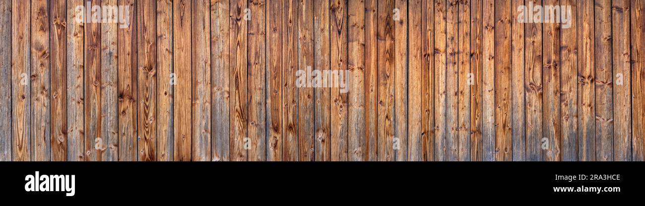 Panoramawand aus Holz einer Scheune aus braunen vertikalen, bereits verwitterten Brettern Stockfoto