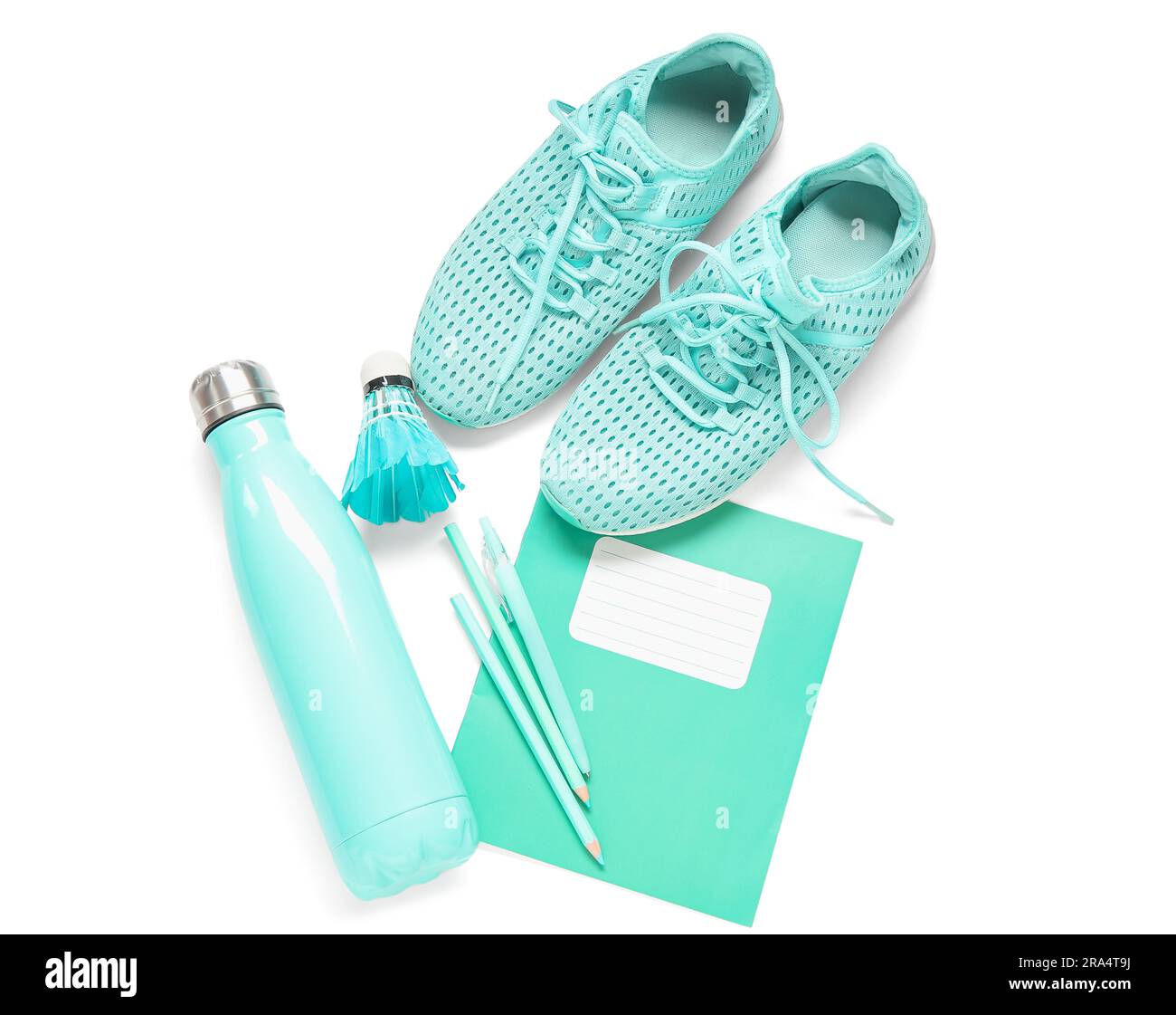 Turnschuhe mit einer Flasche Wasser, Badminton-Shuttle und verschiedene Schreibwaren isoliert auf weißem Hintergrund Stockfoto
