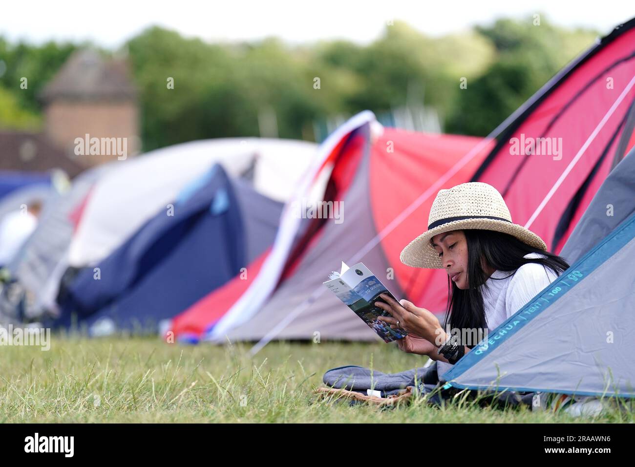 Ein Zuschauer liest das Wimbledon-Programm aus den Schlangen vor den Meisterschaften, die am Montag beginnen. Foto: Sonntag, 2. Juli 2023. Stockfoto