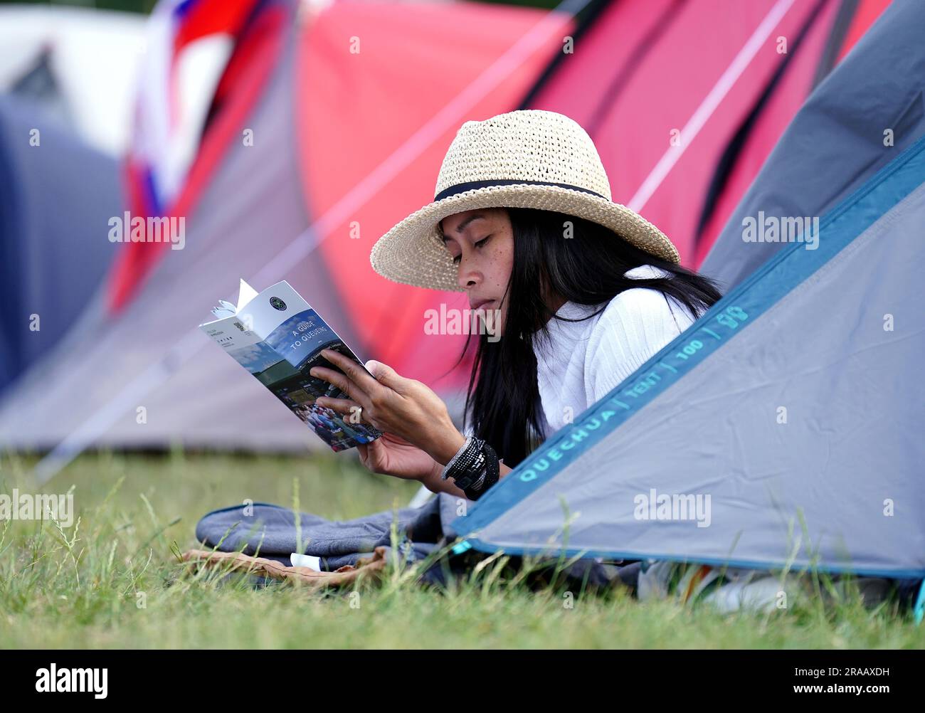 Ein Zuschauer liest das Wimbledon-Programm aus den Schlangen vor den Meisterschaften, die am Montag beginnen. Foto: Sonntag, 2. Juli 2023. Stockfoto