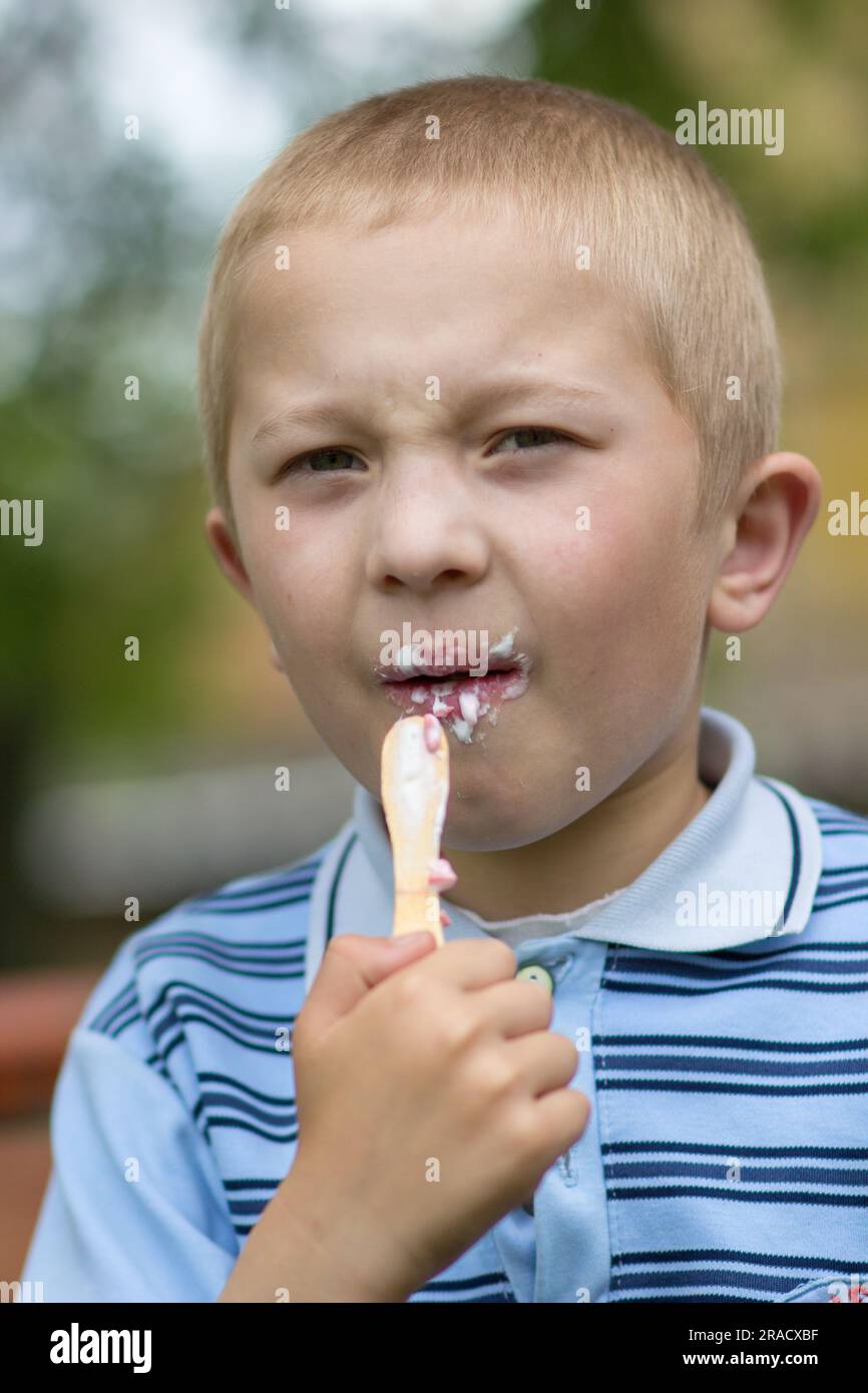 Porträt eines Jungen, der Eiscreme auf einer Zauberstab-Nahaufnahme isst Stockfoto