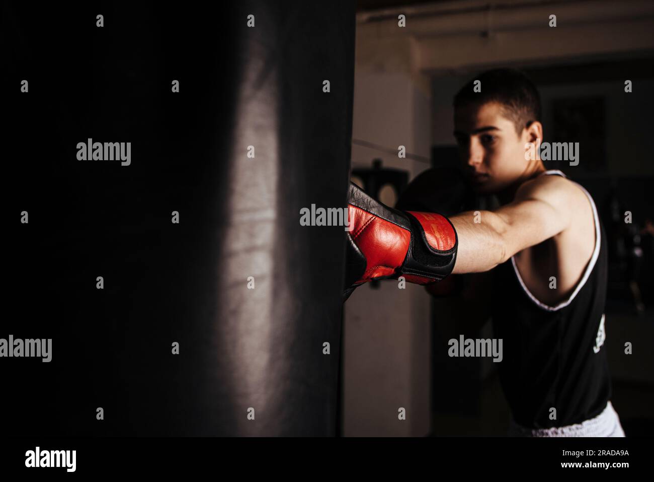 Junger Boxer, der während des Trainings Hit boxt. Stockfoto