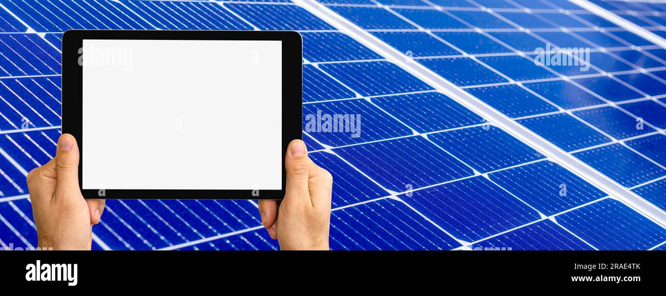 Digitales Tablet mit leerem Bildschirm in den Händen auf blauem Sonnenkollektor. Stockfoto