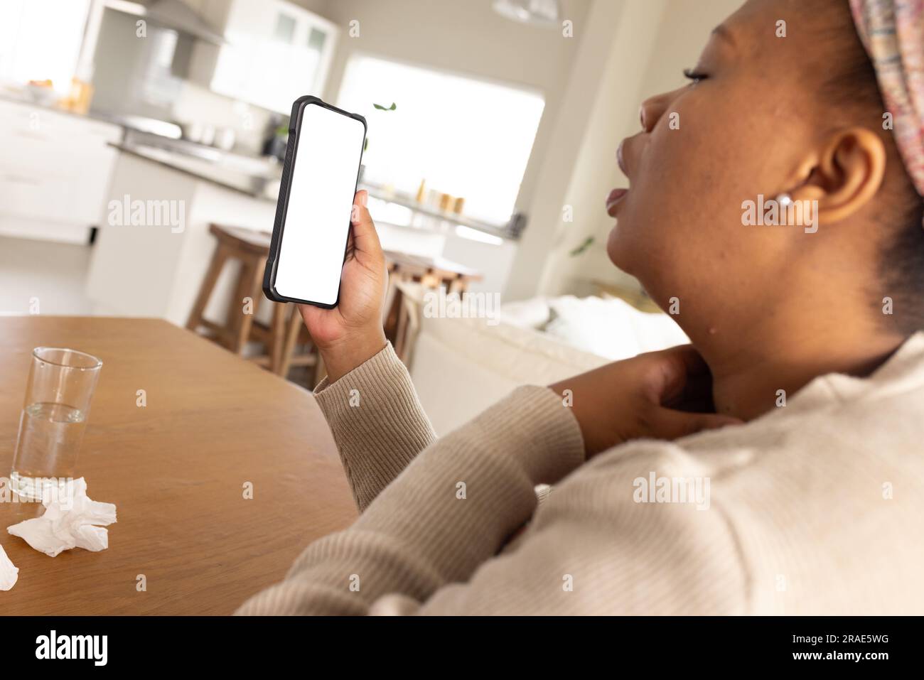 afroamerikanische Frau, die ein Smartphone mit Kopierraum zur Online-Beratung mit einem Arzt benutzt Stockfoto