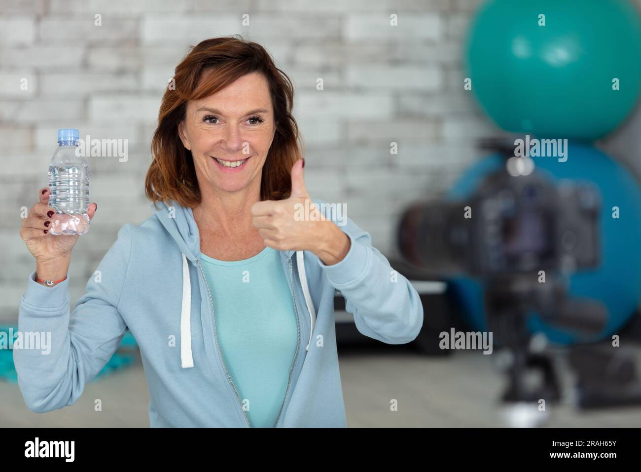 Bloggerin Senior Frau, die zu Hause Yoga macht Stockfoto