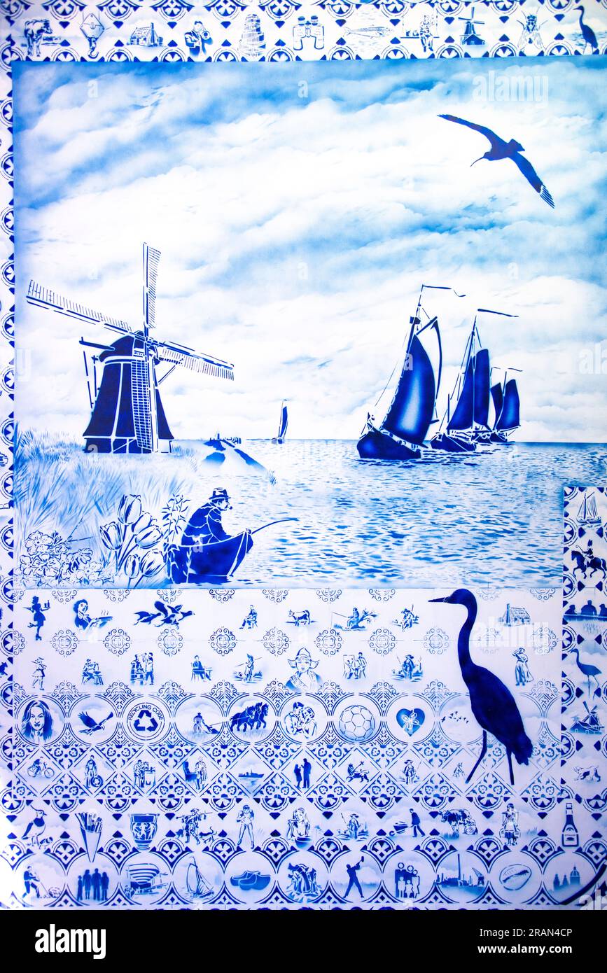 Blau-weiße Fliesen mit einer niederländischen Windmühle und Seeschuppen und verschiedenen niederländischen Ikonen Stockfoto