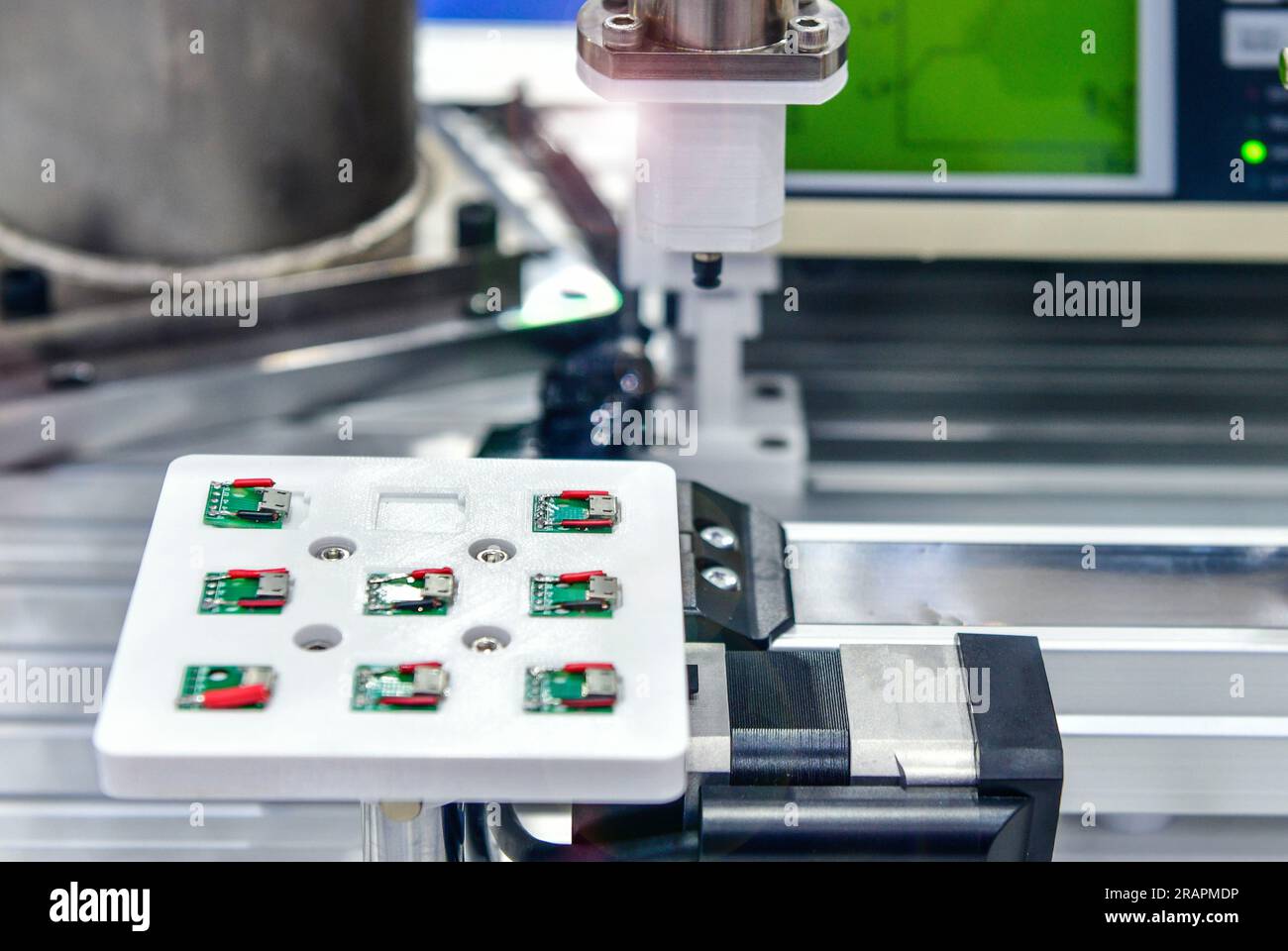 Fabrikmaschinen bei der Arbeit wird Eine kleine Leiterplatte in einem automatisierten Roboterarm montiert Stockfoto