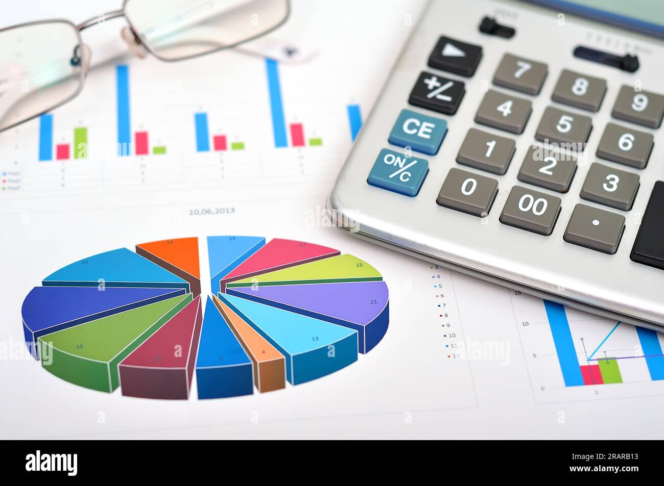 Finanzdiagramm auf Tisch mit Taschenrechner und Brille Stockfoto