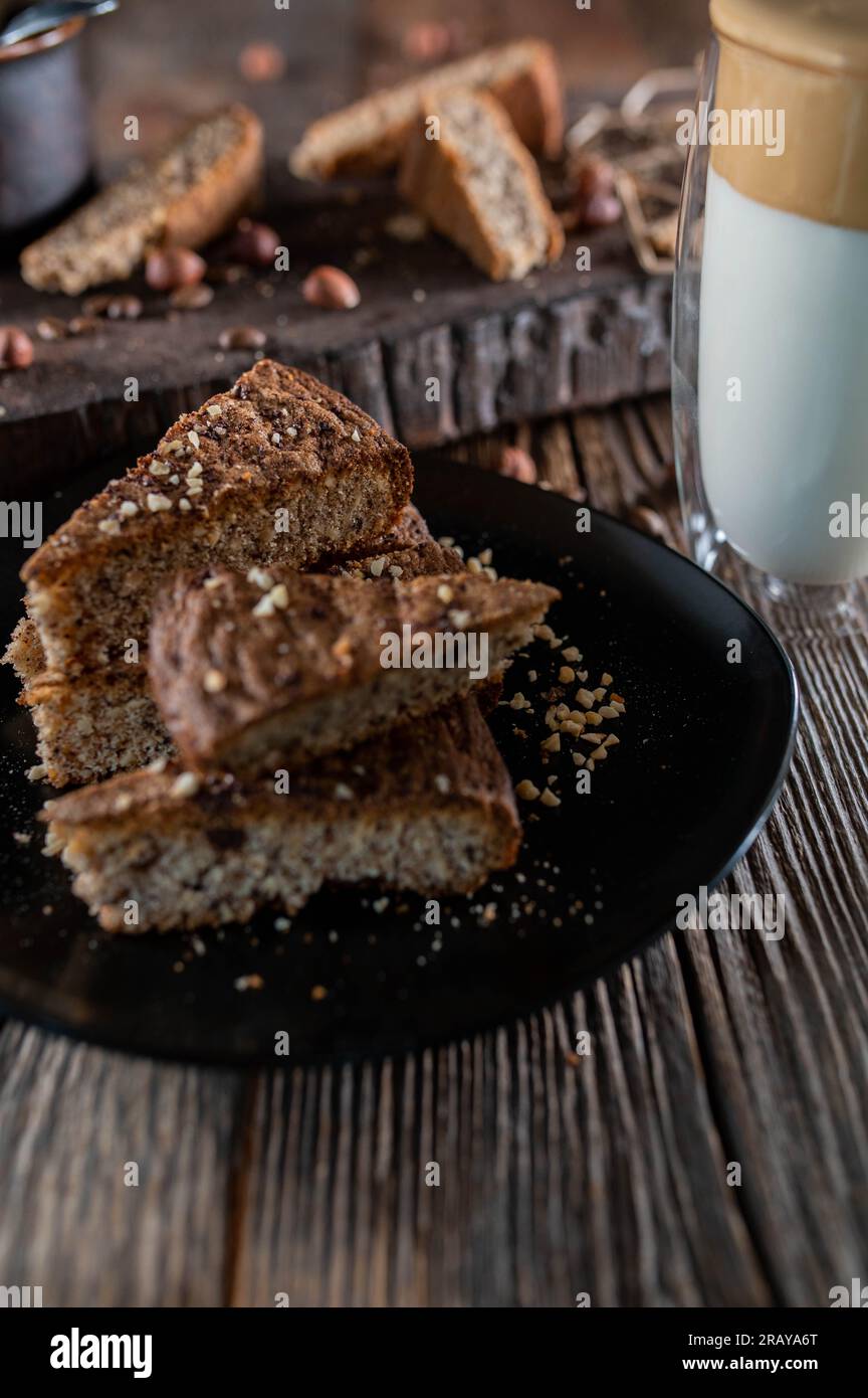 Nusskuchen mit Dalgona-Kaffee auf einem Holztisch Stockfoto