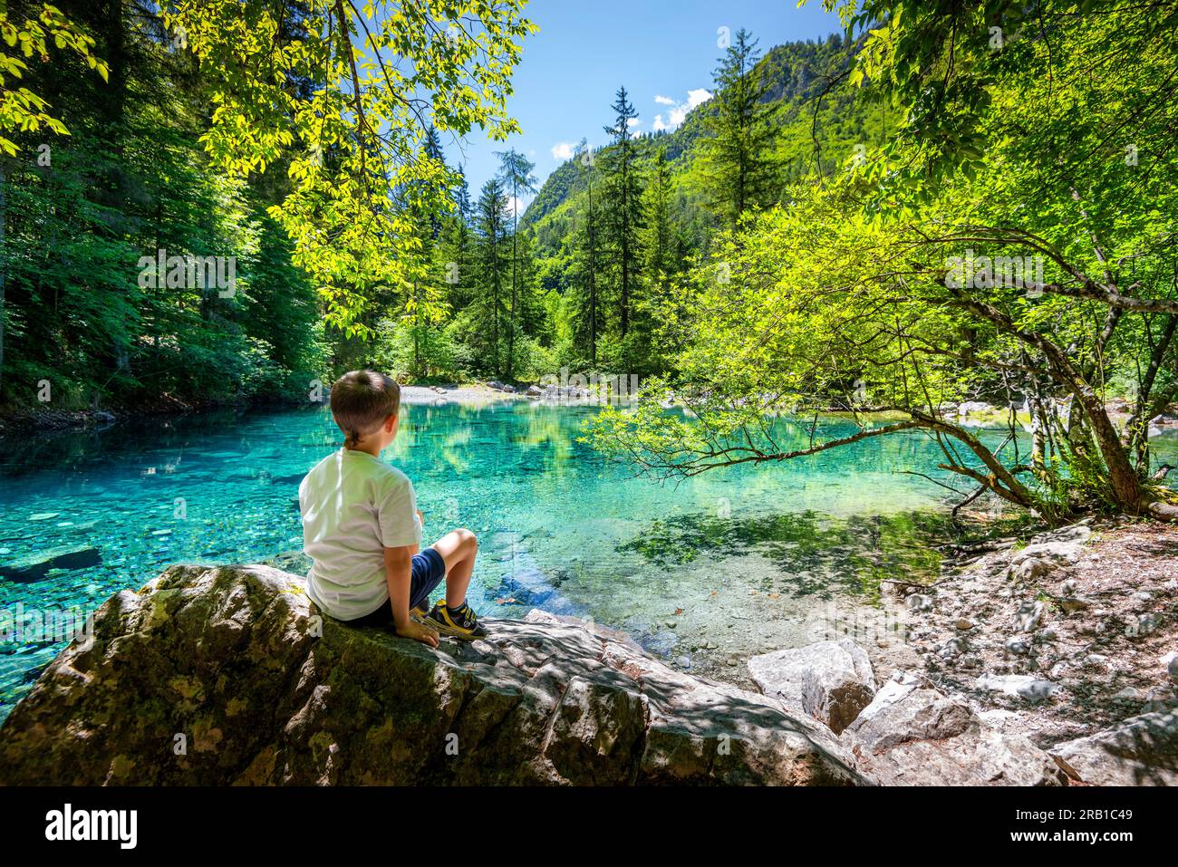 Ein Kind ruht sich nach einer guten Wanderung in Richtung dieses smaragdgrünen Alpensees aus. Europa, Italien, Trentino Südtirol, Trient District, Ville d'Anaunia Stockfoto